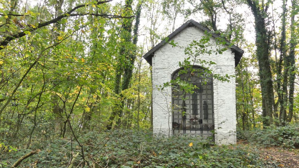 Kleine weiße Kapelle im Wald.